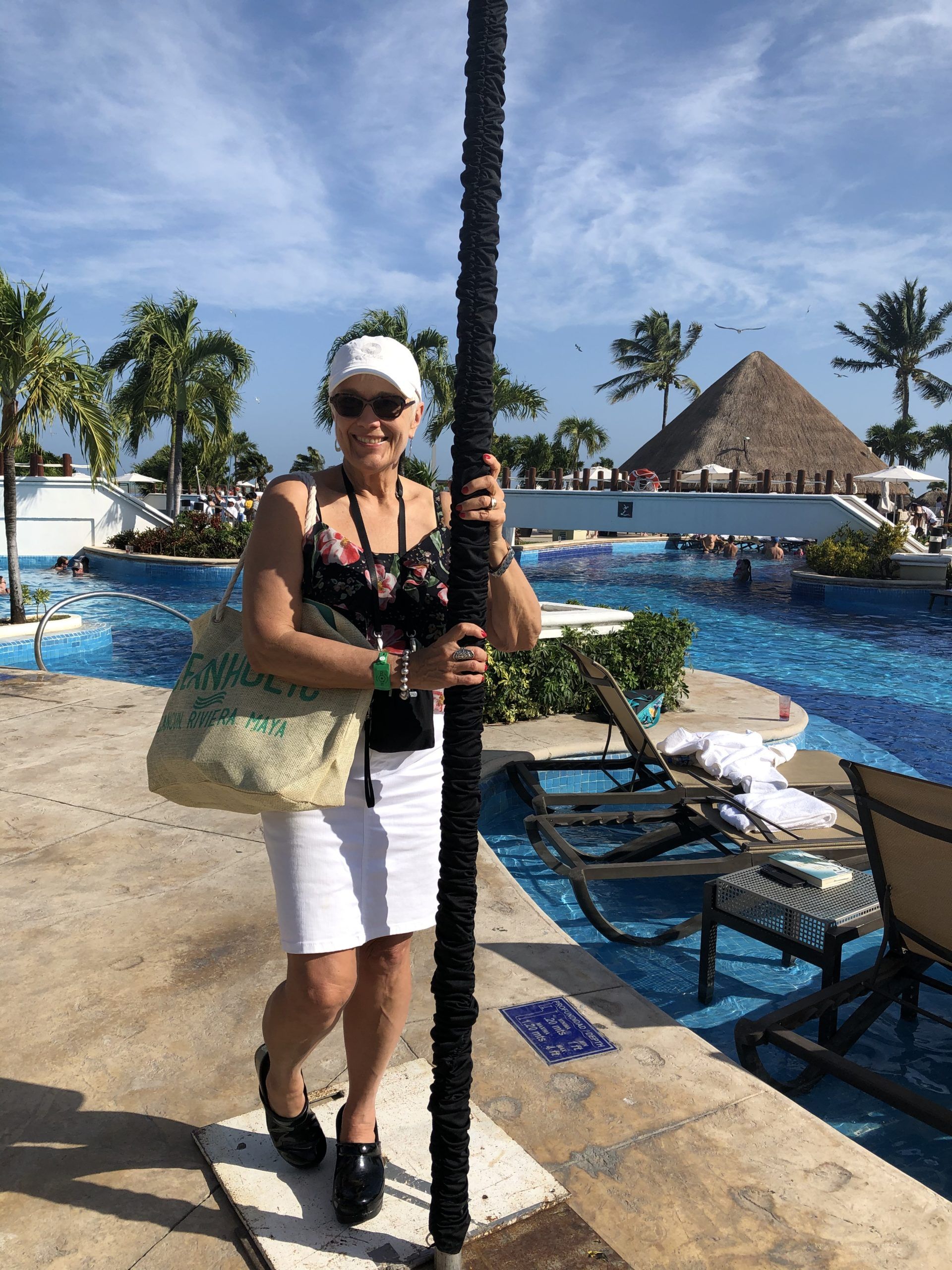 Diane standing by a pool