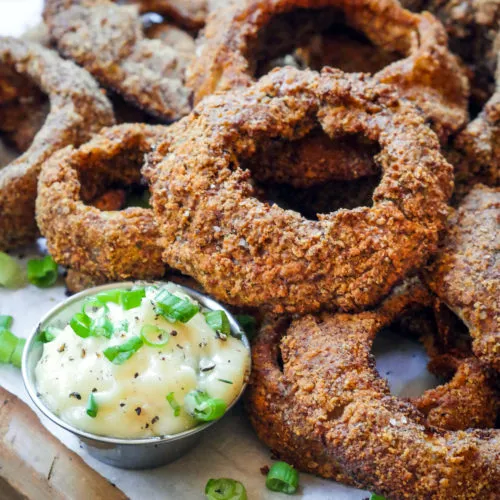 Almond crusted onion rings with green onion-cracked pepper aioli