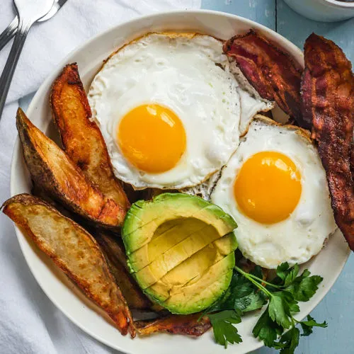 Breakfast bowl with potatoes, avocados, eggs sunny-side up