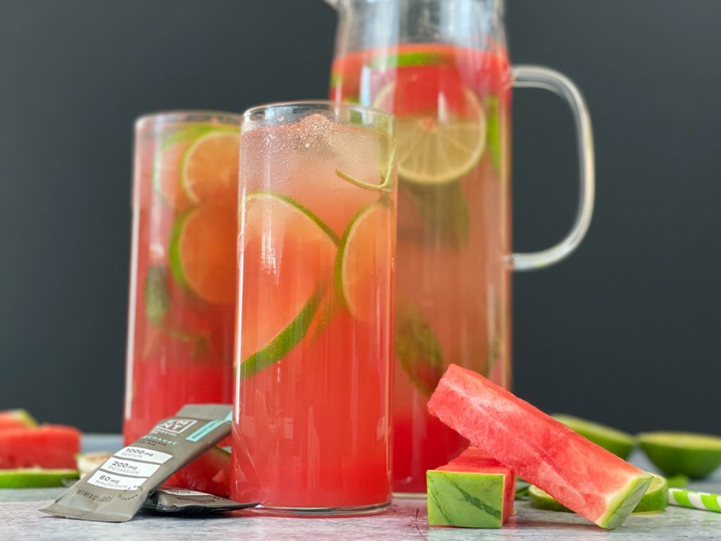 Two glasses and a pitcher of LMNT Watermelon Refresher