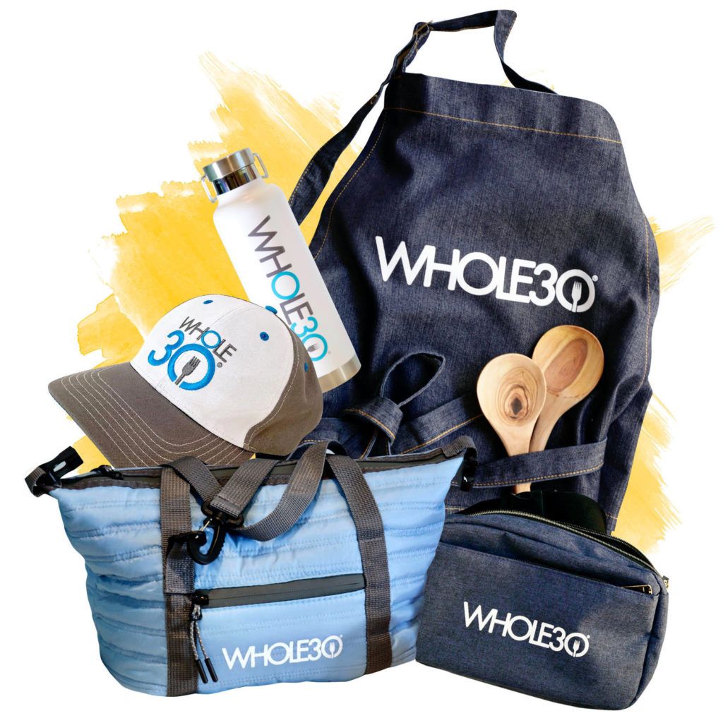 An image of the Whole30 Merchandise collection including the Whole30 Waterbottle, Whole30 Lunchbox, Whole30 Hat, Whole30 Apron, and the Whole30 sling pack.