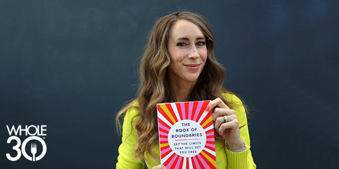 Melissa Urban holding a copy of her book, The Book of Boundaries.
