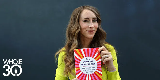 Melissa Urban holding a copy of her book, The Book of Boundaries.