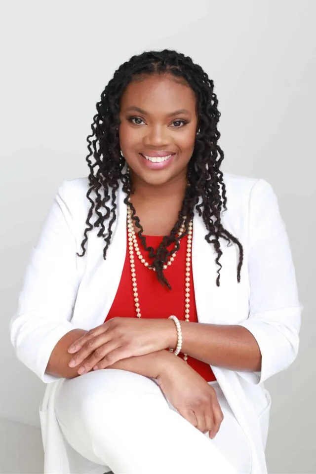 Dr.Sayida Peprah sitting and smiling at the camera.