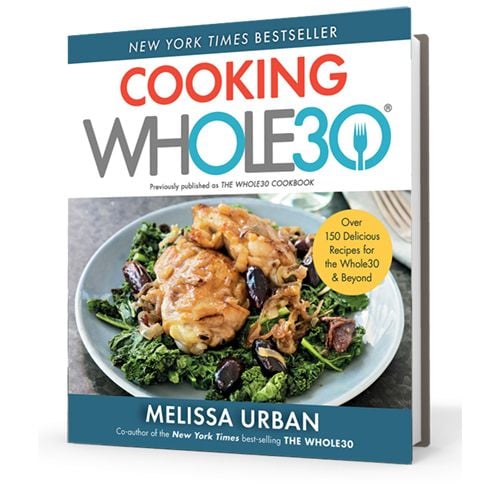 Cooking Whole30 cookbook on top of granite countertop next to a bowl of lemons