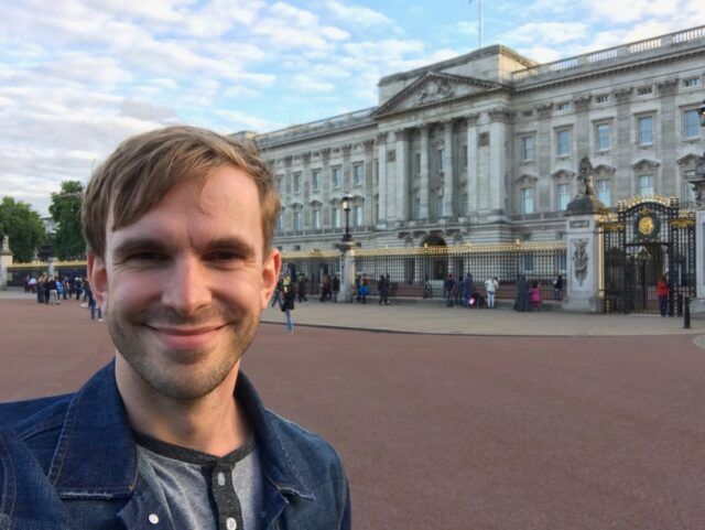 Aaron smiling and taking a selfie