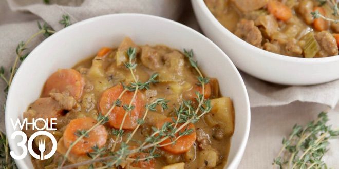 Two bowls of Creamy Whole30 Sausage and Potato Soup topped with fresh thyme
