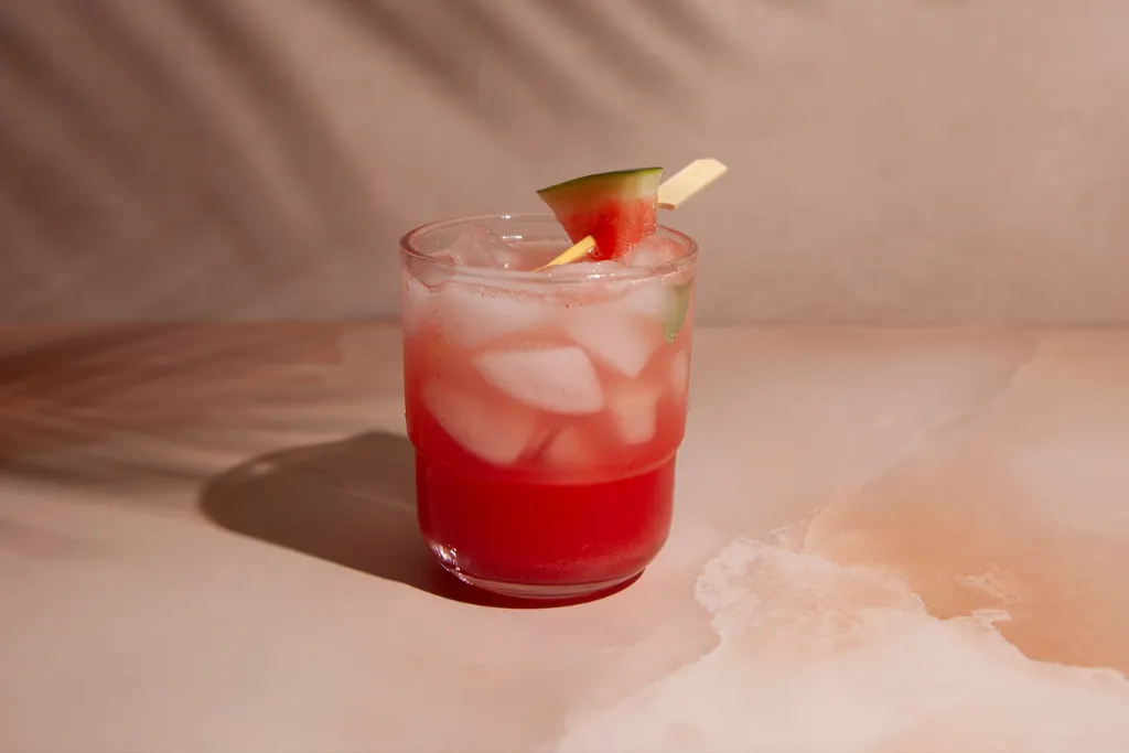 Watermelon Basil Fizz Mocktail on light pink marble background