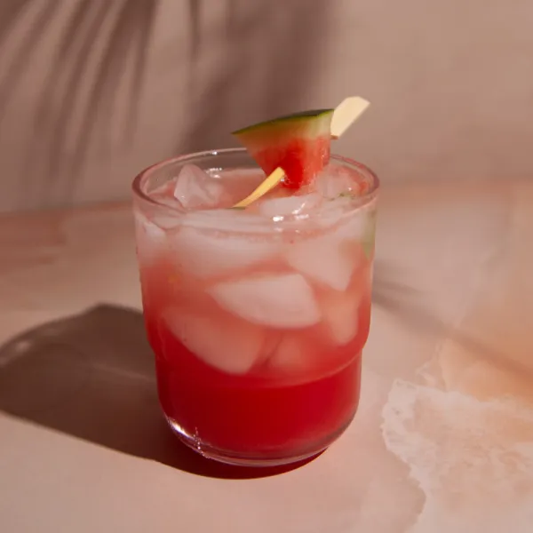 Watermelon Basil Fizz Mocktail on light pink marble background